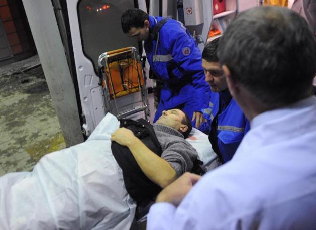 Medics wheel a victim of a bomb explosion at Domodedovo airport from an emergency vehicle in Moscow